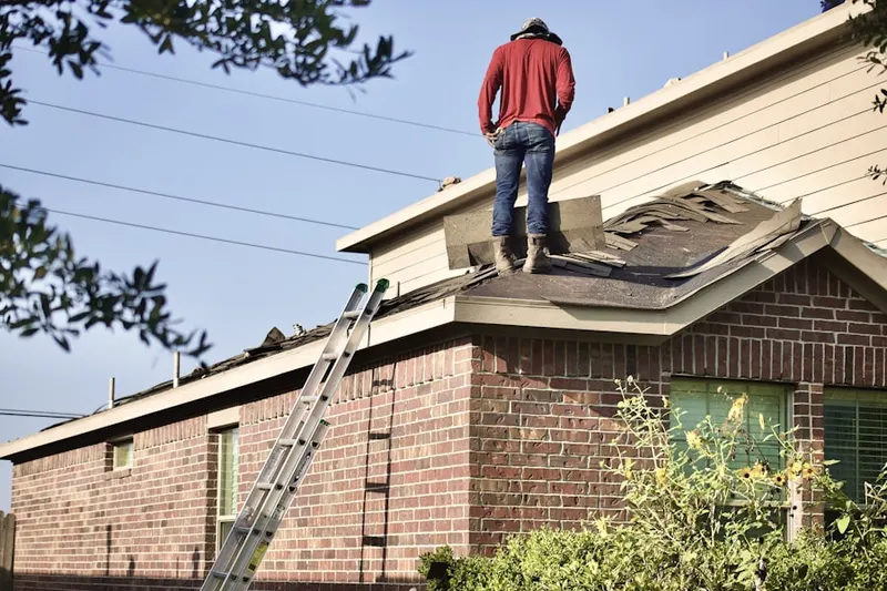 Professional roofer working on a residential roof in Brookestone